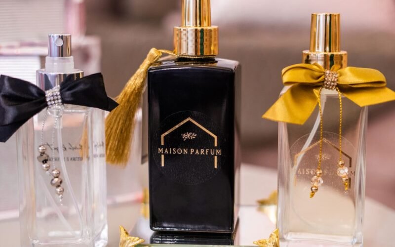 Elegant perfumes on a vanity decorated with ribbon