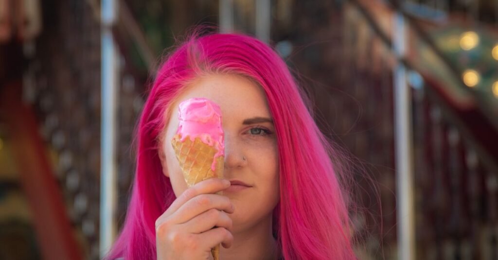 Vibrant neon pink hair against bathroom mirror light