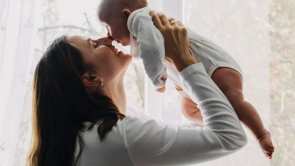 New mother applying gentle skincare in bathroom mirror