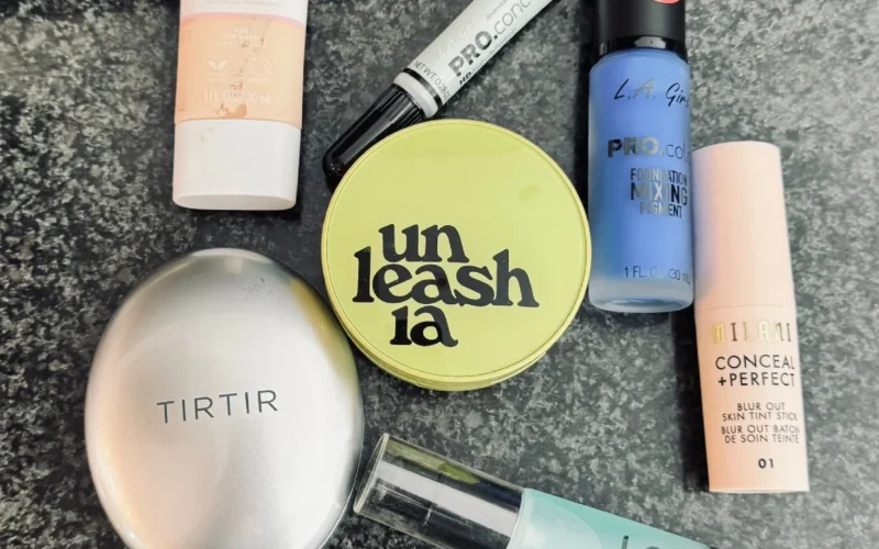 Flat lay of cruelty-free drugstore foundations under fifteen dollars