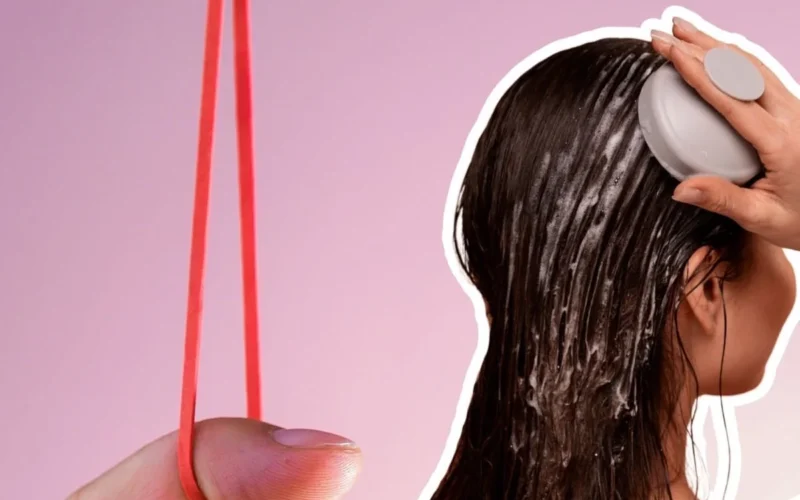 Wet hair being massaged with scalp cleanser and rubber band