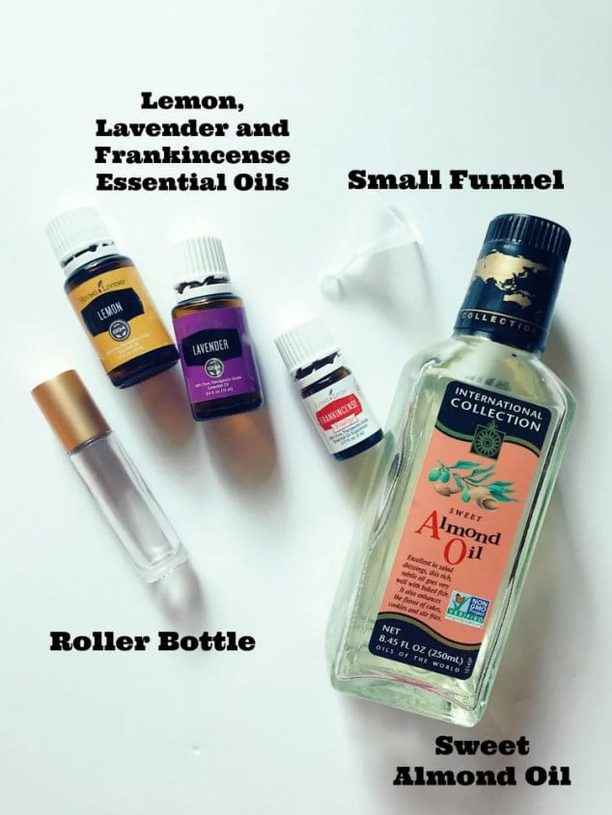 Essential oil bottles and under eye roller beside flowers
